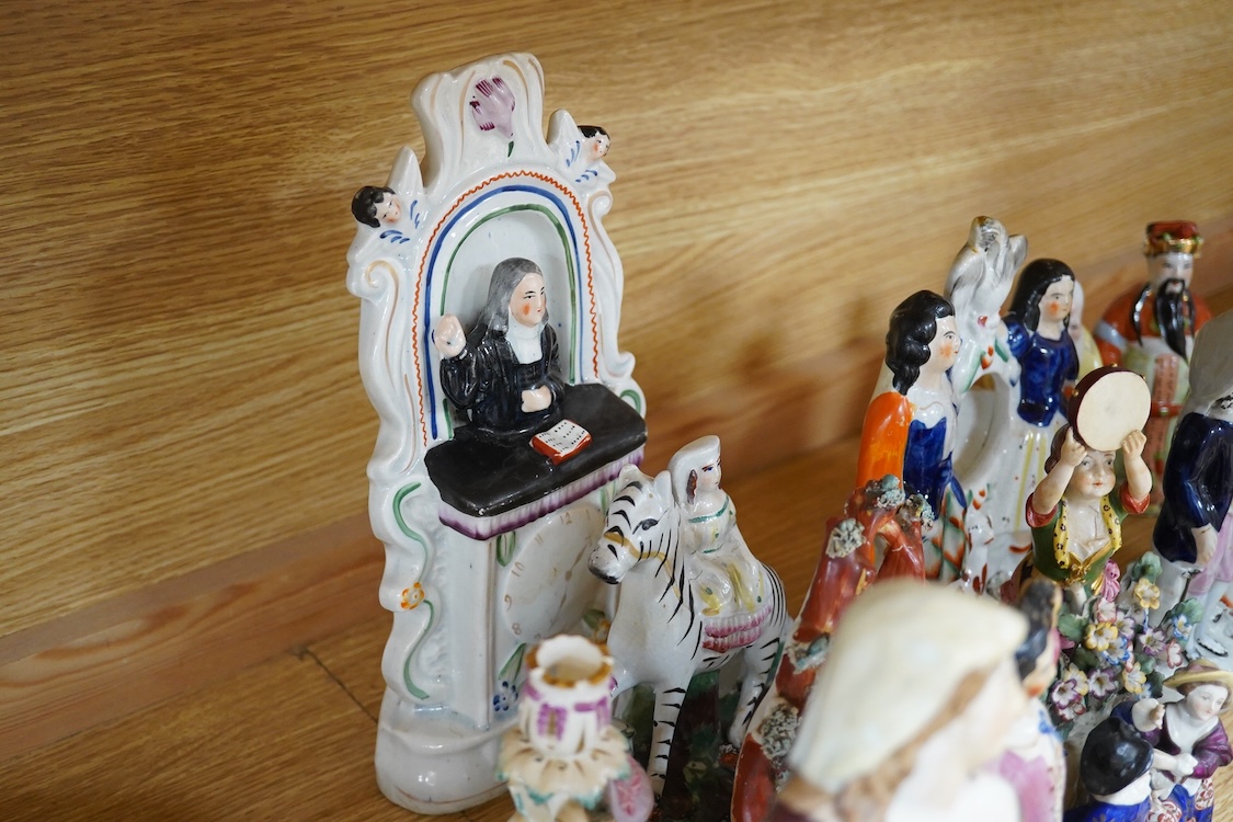A collection of 19th century porcelain and ceramic figures, mostly Staffordshire, largest 28cm high